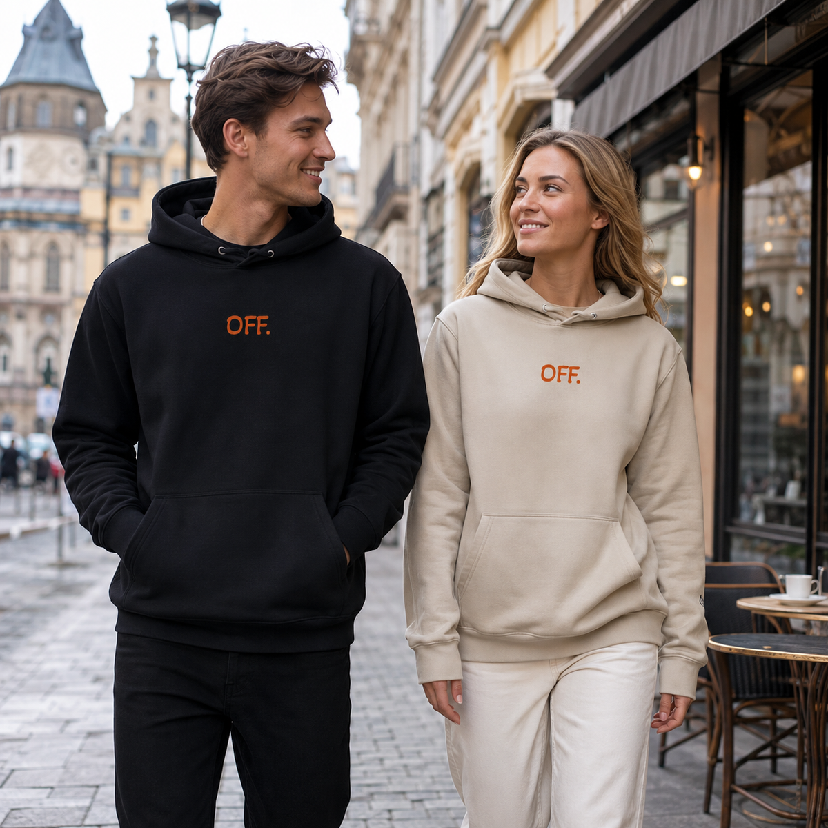 Young couple wearing black and desert dust organic hoodies with orange OFF embroidery