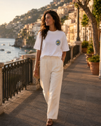 Woman wearing white Amalfi Road Club T-shirt with small front logo on the Amalfi Coast