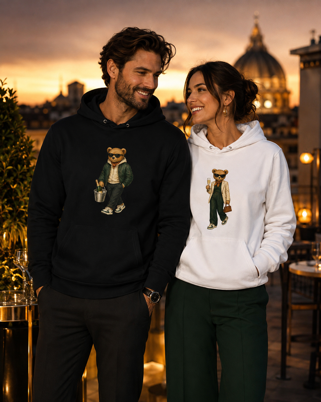 Young couple wearing Champagne Weekend and Prosecco Mood Bear organic cotton hoodies by My Keepsake.