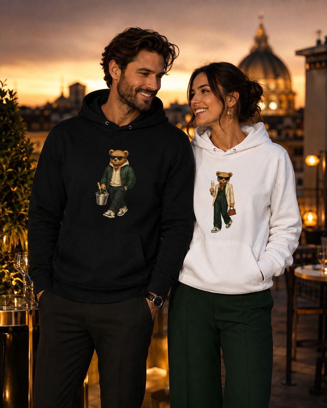 Young couple wearing Champagne Weekend and Prosecco Mood Bear organic cotton hoodies by My Keepsake.