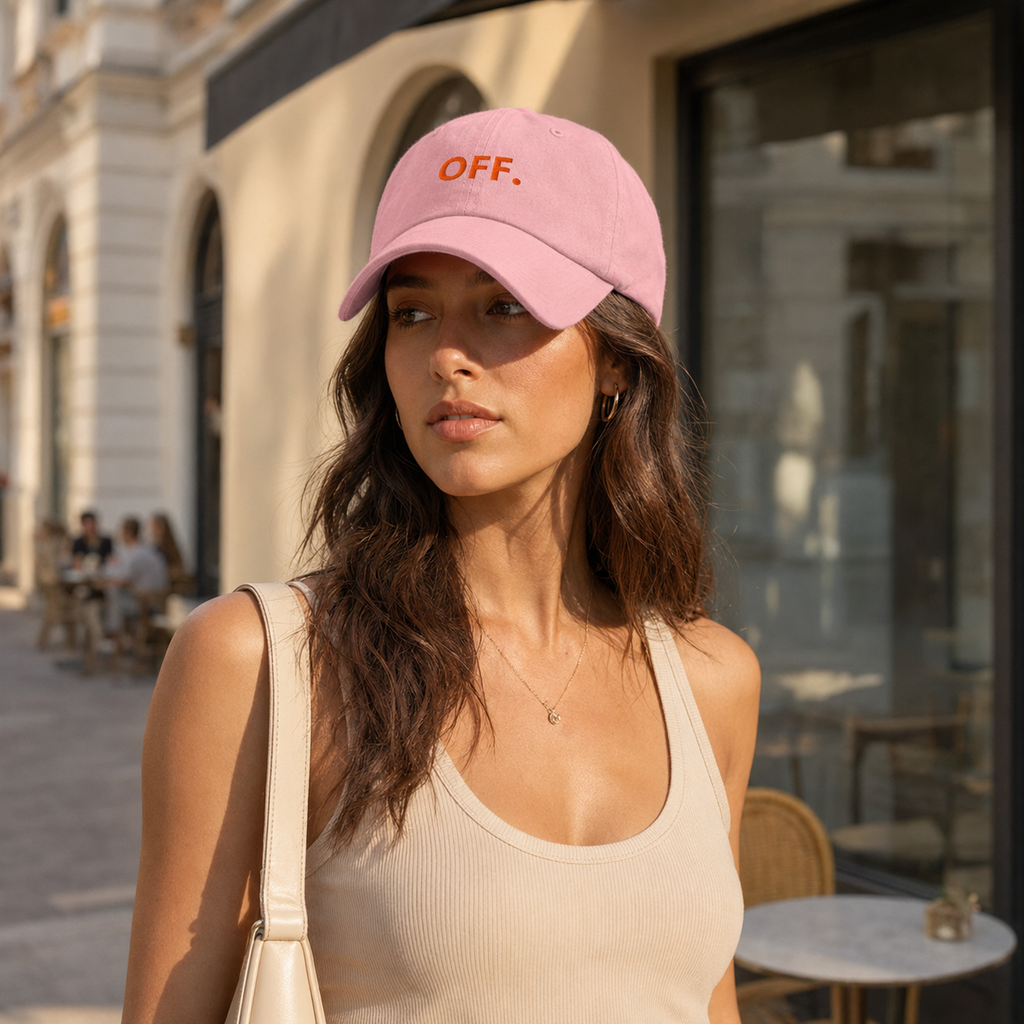 Stylish woman wearing a pink OFF embroidered cap at a Prague café.