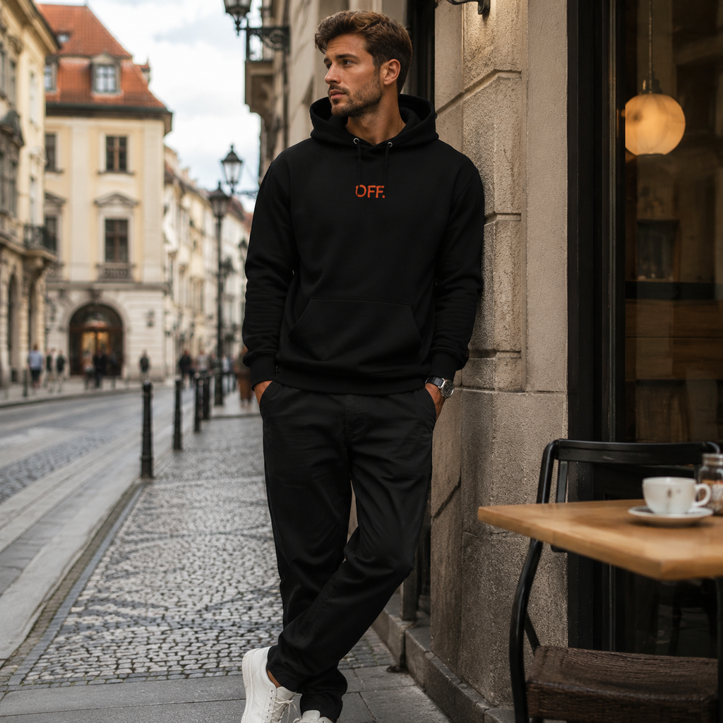 Young man wearing a black organic cotton hoodie with orange OFF embroidery