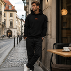 Young man wearing a black organic cotton hoodie with orange OFF embroidery