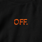 Close-up of orange OFF embroidery on a black oversized organic cotton T-shirt.