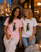 Two women wearing pink and white Prosecco Bear organic cotton T-shirts at a city prosecco bar