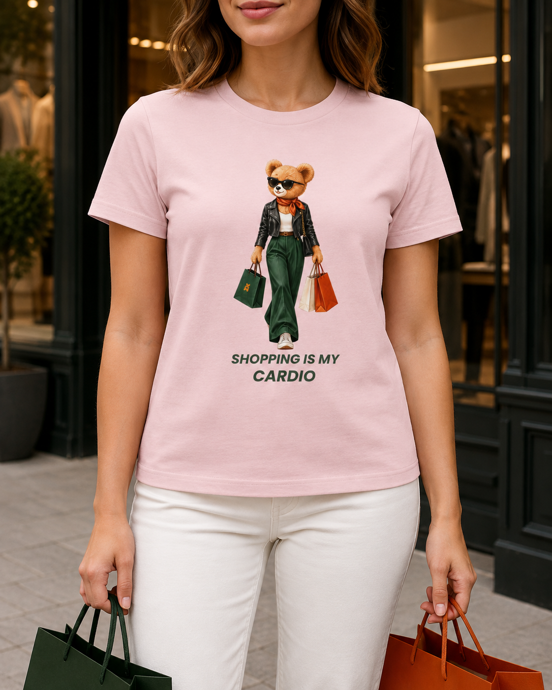 Close-up of the teddy bear print on a pink Shopping Is My Cardio T-shirt