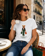 Woman wearing a white Shopping Is My Cardio T-shirt at an outdoor café